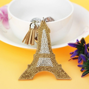 Close-up of rhinestone Eiffel Tower keychain with brown tassel and silver metal clip