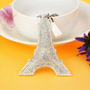 Macro shot of Eiffel Tower keychain with colorful rhinestones and white leather tassel