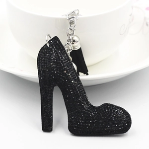 Detailed view of black rhinestone high heel keychain with elegant tassel and silver chain