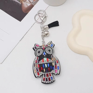 Sparkly rhinestone owl keychain with colorful crystals and black leather tassel charm