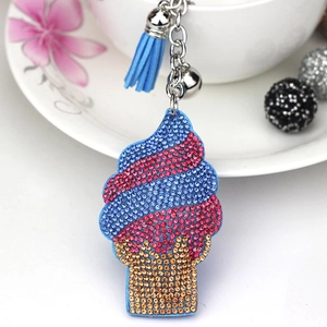 Close-up of crystal ice cream keychain with blue tassel and silver bell detail