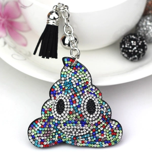 Detailed view of colorful rhinestone-studded poop emoji keychain with black tassels