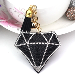 Funkelnder Schlüsselanhänger in Diamantform mit schwarzen Quasten und goldener Glocke