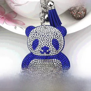 Detailed macro view of rhinestone bear keychain with blue tassels and silver metal chain
