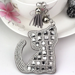 Vue macro du pendentif chat avec cristaux, pompon gris et clochette pour sacs