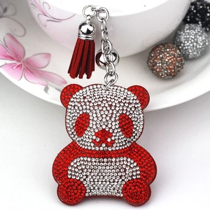 Detail of panda keychain with sparkling red and white rhinestones and a red tassel