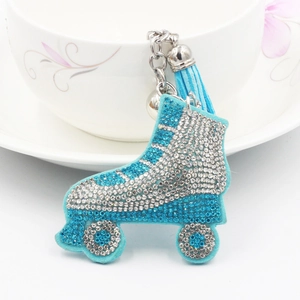 Macro view of blue ice skate keychain with sparkling rhinestones and blue tassel