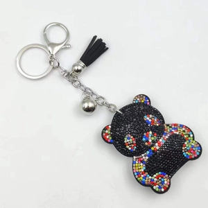 Close-up of rhinestone panda keychain with black tassel, bell, and colorful crystal inlay
