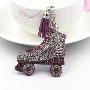 Sparkly purple rhinestone ice skate keychain with elegant tassel on a white cup