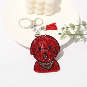 Porte-clés chien classique avec strass rouges, anneau argenté et gland rouge assorti