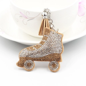 Sparkly rhinestone ice skate keychain with soft brown tassel and silver metal ring