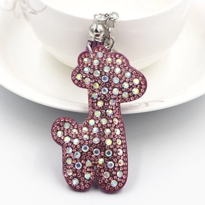 Pudel-Schlüsselanhänger mit rosa Strass und lila Quaste auf weißem Keramikdekor
