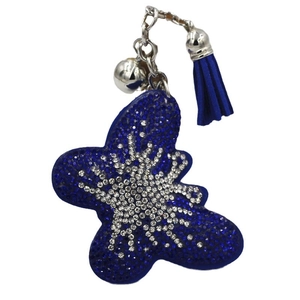 Porte-clés papillon en strass bleu et blanc avec pompon et clochette sur fond blanc pur