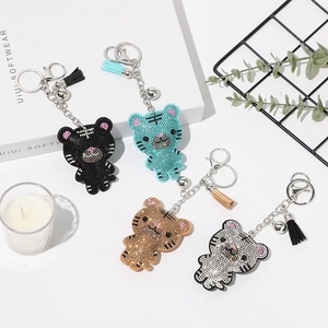 Détails de quatre porte-clés tigre en strass avec glands et petites clochettes