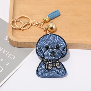 Détails du porte-clés caniche en strass bleus avec clochette dorée et pompon en cuir