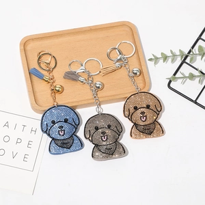 Vue détaillée de porte-clés chien en strass étincelants avec pompons élégants colorés