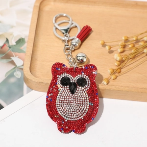 Porte-clés hibou avec strass rouges, gland rouge et petite cloche argentée élégante