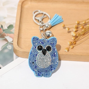 Porte-clés hibou strass bleu avec pompon en cuir et clochette argentée élégante
