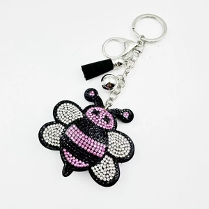 Sparkling pink rhinestone bee keychain with black tassel and silver bell accessory