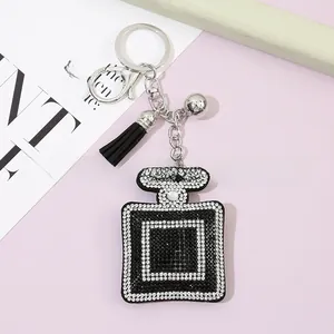 Detailed view of luxury perfume bottle keychain with crystal rhinestones and black tassel