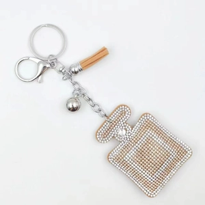Sparkling rhinestone perfume bottle keychain with leather tassel and silver bell charm