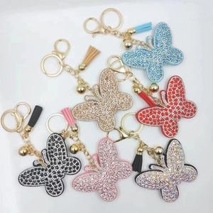 Detail of butterfly crystal keychains with glittering rhinestones and colorful leather tassels
