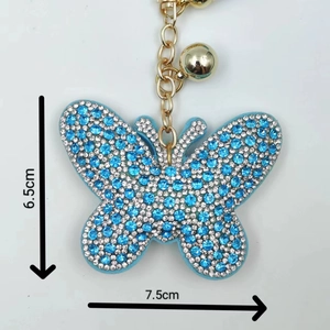 Detail view showing blue butterfly rhinestone keychain with 7.5cm width and 6.5cm height