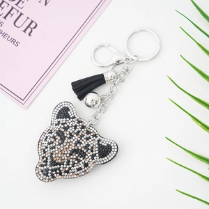 Porte-clés léopard étincelant avec strass et pompon en cuir noir pour sacs à main