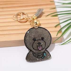 Detail of grey rhinestone cartoon bear keychain with gold clasp and tassel hanging