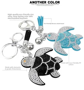 Close-up of sparkling rhinestone turtle keychain with velvet tassel and bell charms