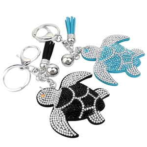 Sparkling rhinestone sea turtle keychain with tassel and bell in blue and black colors
