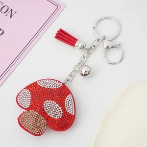 Creative red mushroom keychain with sparkling rhinestones and a stylish leather tassel