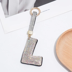 Detailed view of rhinestone letter L keychain with a sparkling rainbow diamond strap