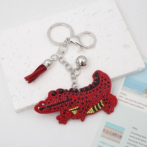 Cartoon red crocodile keychain with sparkling rhinestones, red tassel and silver bell detail
