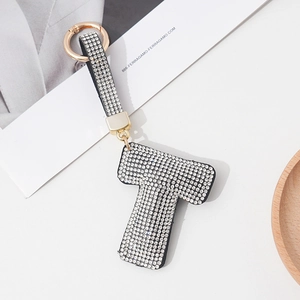 Detail of letter T keychain with sparkling rhinestones and gold spring buckle