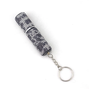 Detail view of mini 10ml perfume bottle with purple rhinestones and silver keychain ring