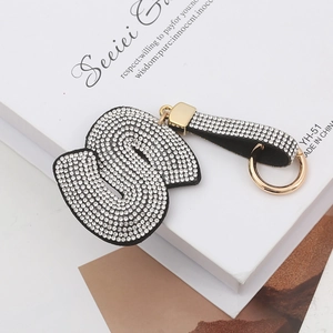 Détail d'un porte-clés doré de luxe avec une grande lettre S ornée de strass brillants