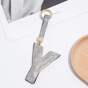 Detailed macro view of letter Y keychain with sparkling rhinestones and golden spring clasp