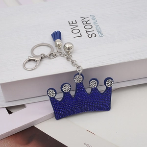 Elegant crown keychain with deep blue rhinestones, tassel, and silver bell accessory