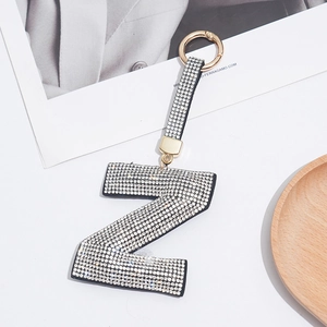 Close-up of letter Z keychain with white rhinestones and golden round metal clasp