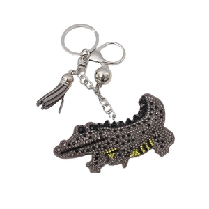 Sparkling rhinestone crocodile keychain with gray leather tassel and silver metal hardware