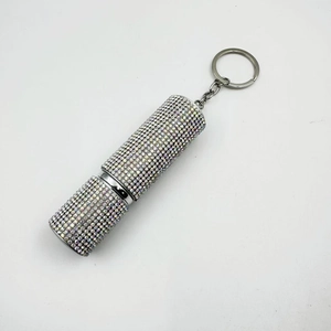 Detail of a mini 10ml portable perfume spray bottle encrusted with shiny colorful rhinestones
