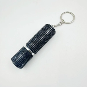 Detail of a 10ml mini perfume bottle with black rhinestones and silver keychain