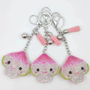 Three-piece set of cartoon rhinestone keychains with pink tassels and bells
