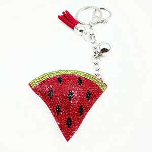 Detail of watermelon keychain with red green rhinestones, tassel and small silver bell