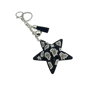 Leopard print star keychain with rhinestones, black tassel, and silver hardware on white background