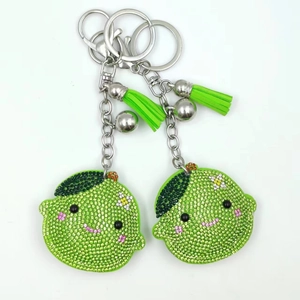 Cute lime keychain with green rhinestones, silver lobster clasp and leather tassel