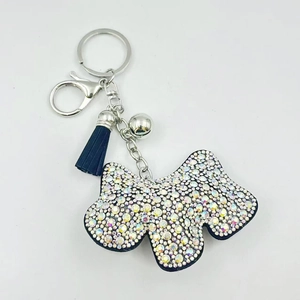 Portachiavi a forma di cane con strass brillanti, nappa blu scuro e campanello d'argento