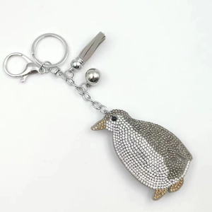 Elegant penguin keychain with sparkling crystals and a stylish grey leather tassel