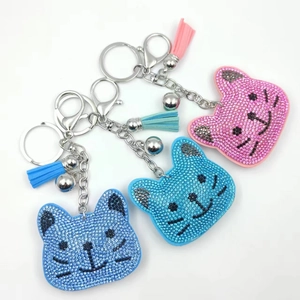 Sparkling rhinestone cat keychain with plush velvet base, bells and colorful tassels